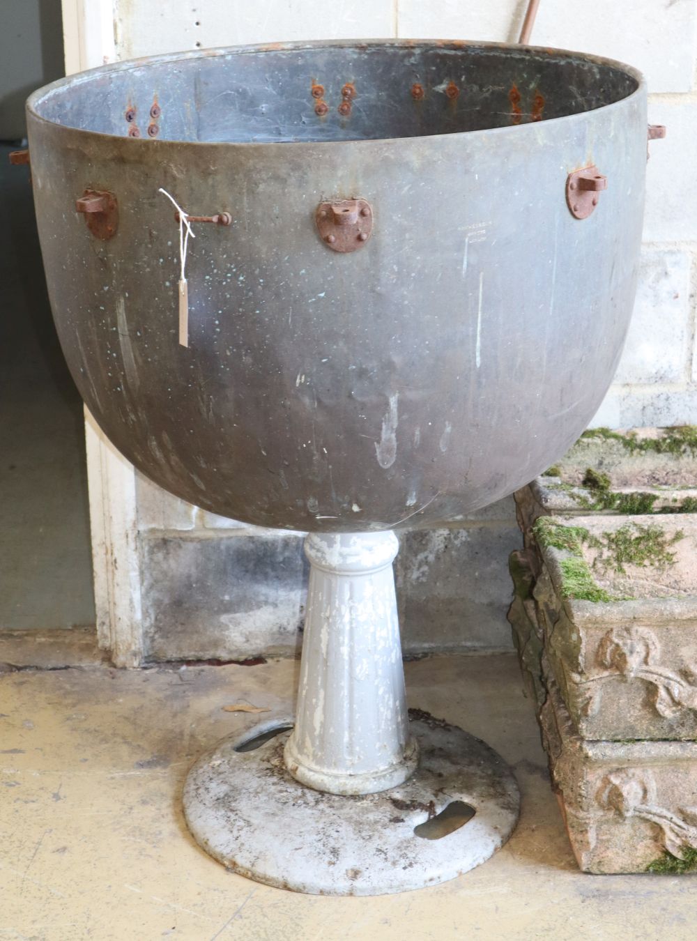 A Hawkes & Son large brass kettle drum, now mounted on an associated pedestal, W.76cm, H.101cm